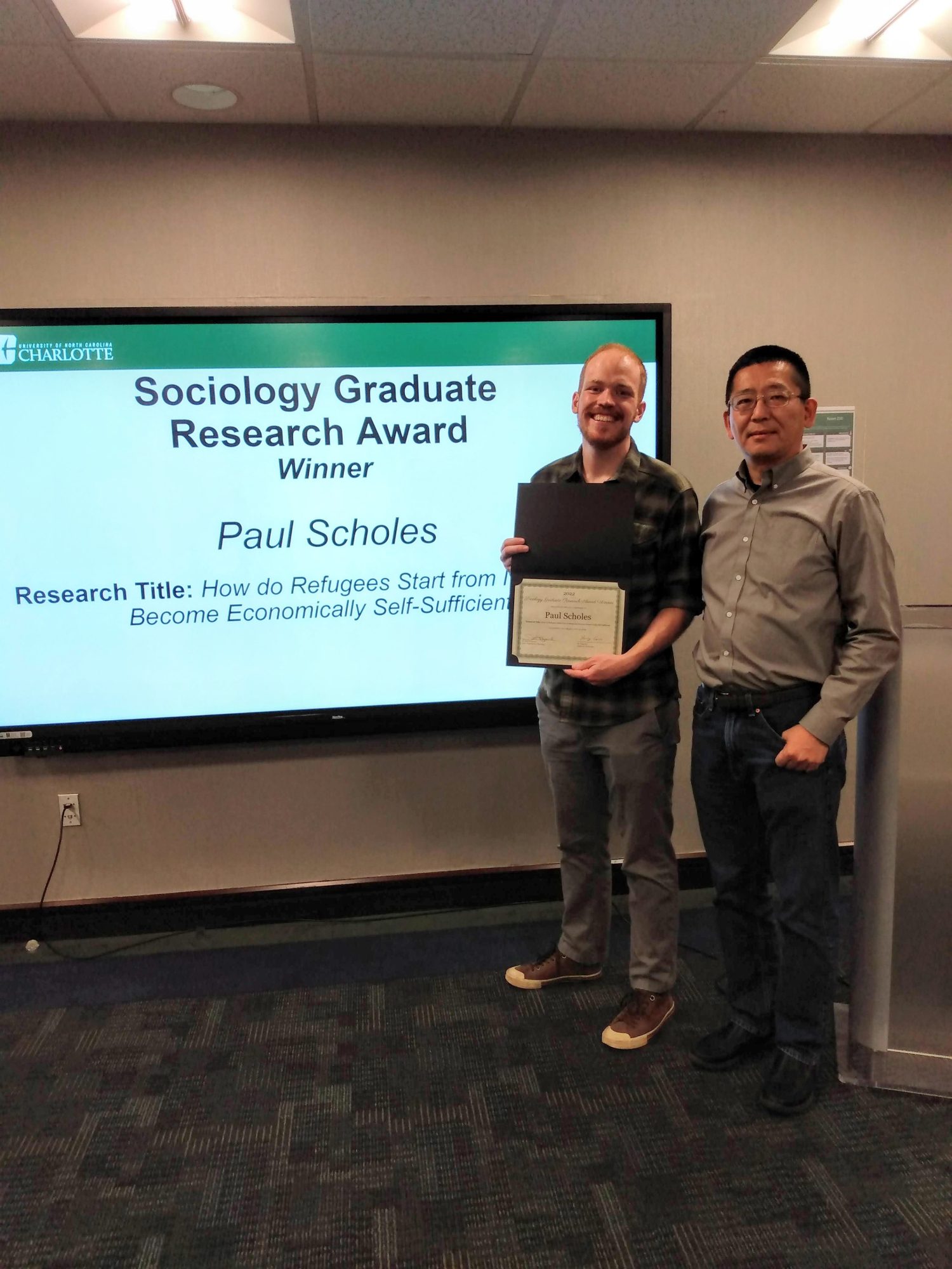 Paul Scholes, winner of the Sociology Graduate Research Award, with the Graduate Program Coordinator Dr. Yang Cao.